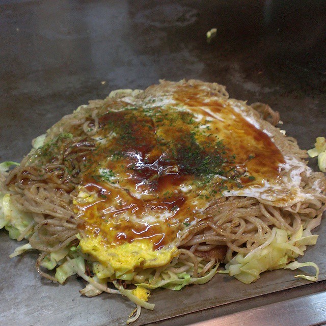an asian dish of noodles with sauce and a fork