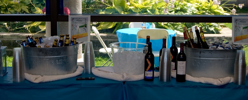 two buckets that have bottles of wine in them