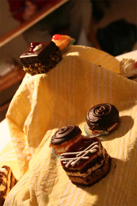 three cakes sitting on a yellow cloth