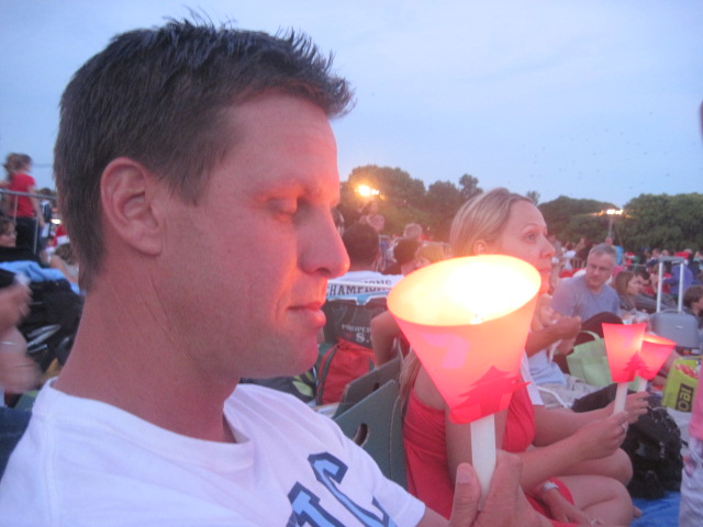 a man with an illuminated cone at a soccer game