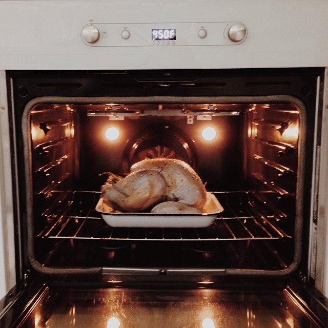 the oven is full with a roast turkey cooking