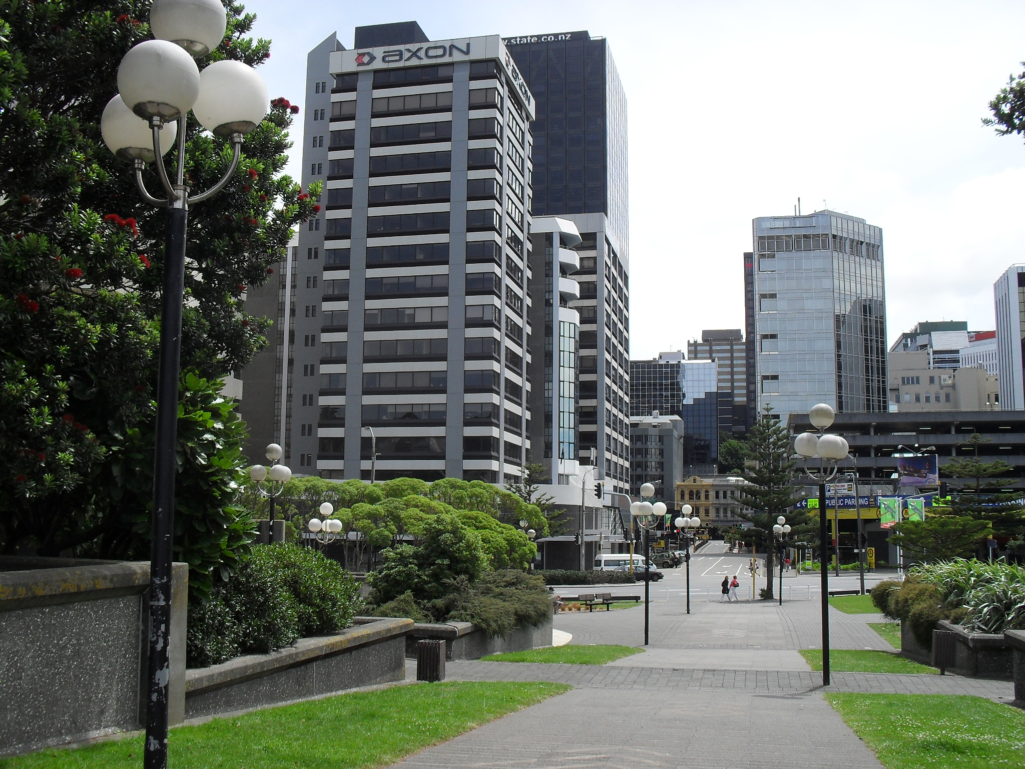 a walkway leads to two buildings in a city