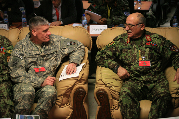 two men in military uniforms sitting on couches