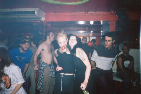 a group of people standing around in a bar