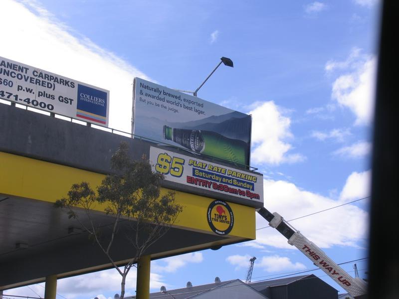 a sign is mounted above the top of a gas station