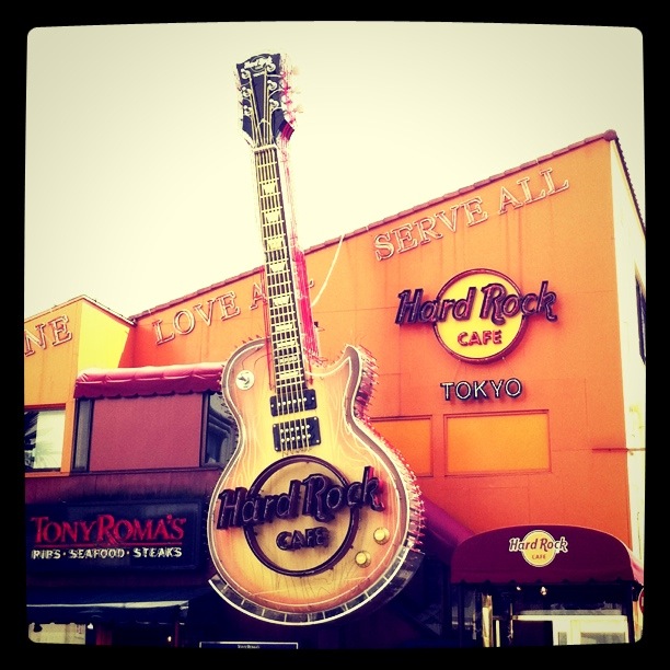 a guitar sign on display outside a hard rock cafe