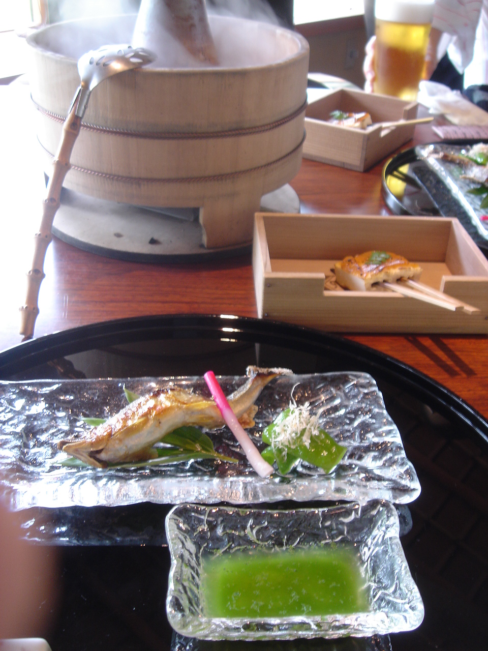 a glass plate with food on it, and a drink in the glass