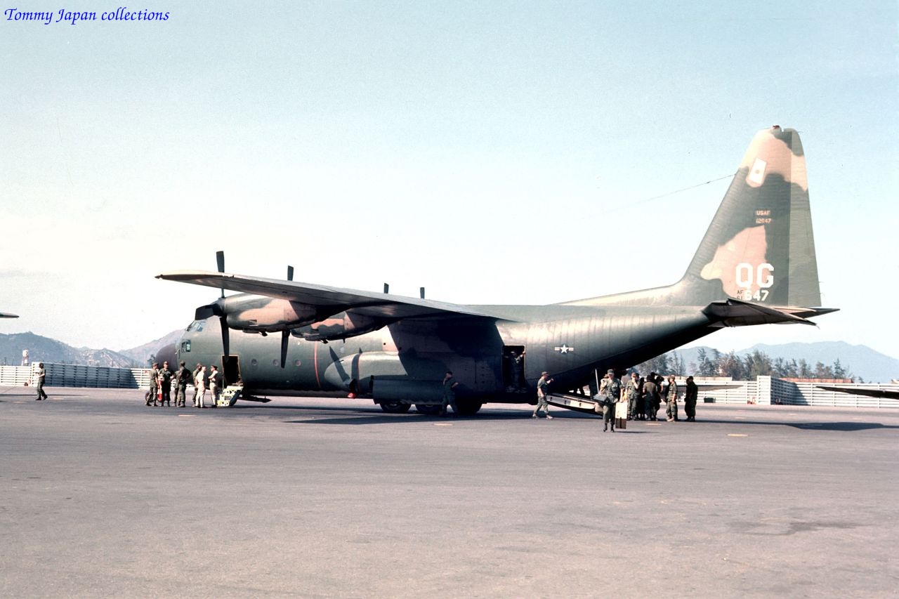 military personnel standing next to an airplane on a runway