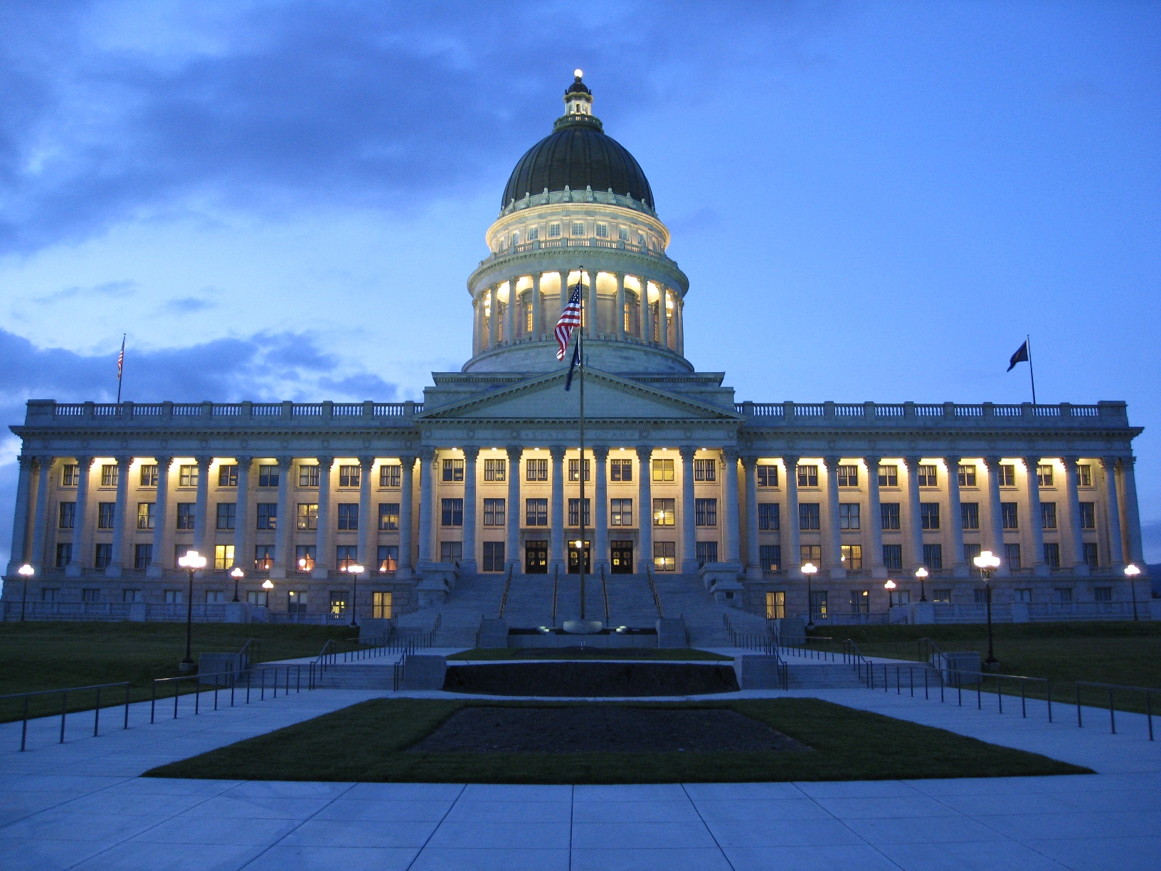 a large government building lit up at dusk