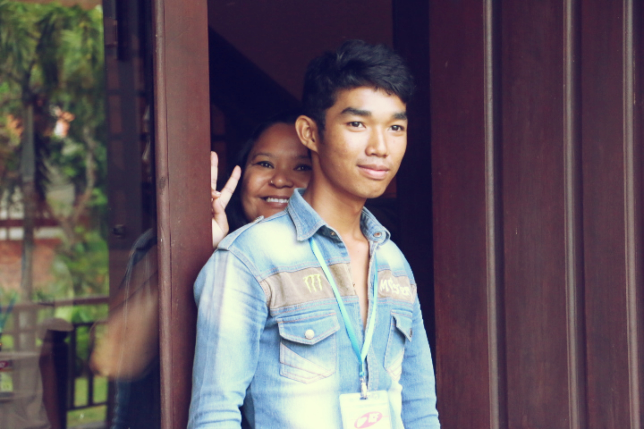 two smiling young men are posing for a po