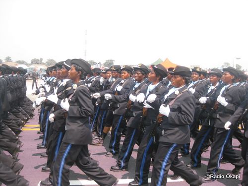 a parade of people dressed in black uniforms