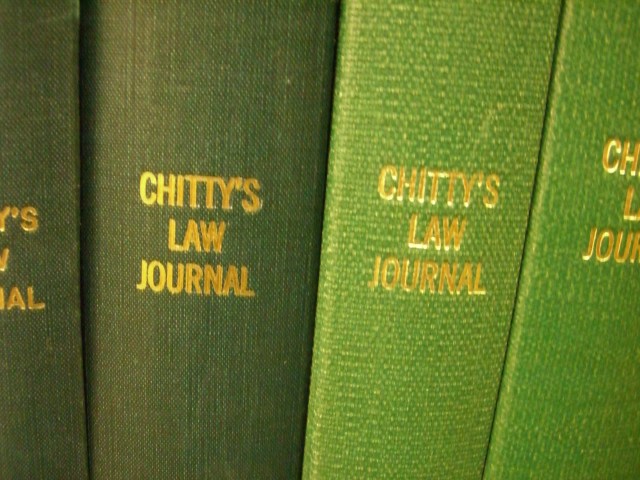 the spines of three green law books