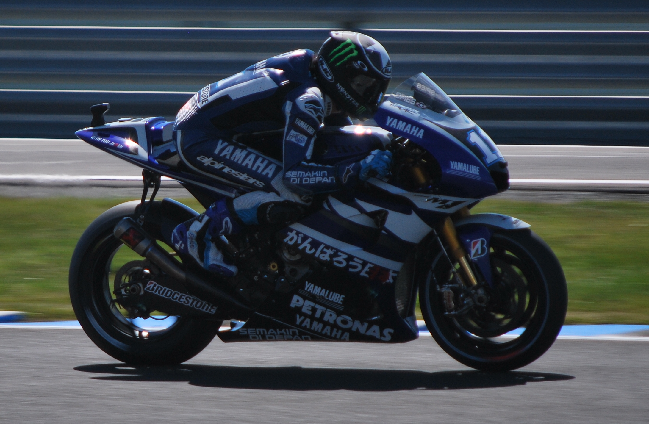 a man on a motorcycle racing down the track