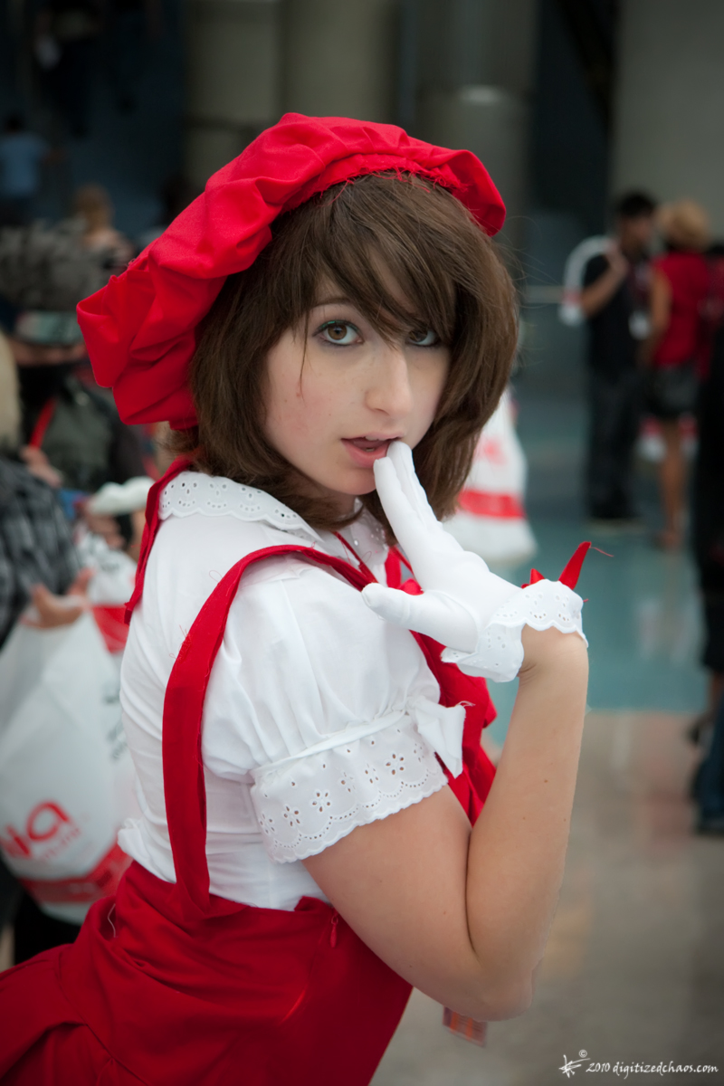 a beautiful young lady in red and white holding a napkin