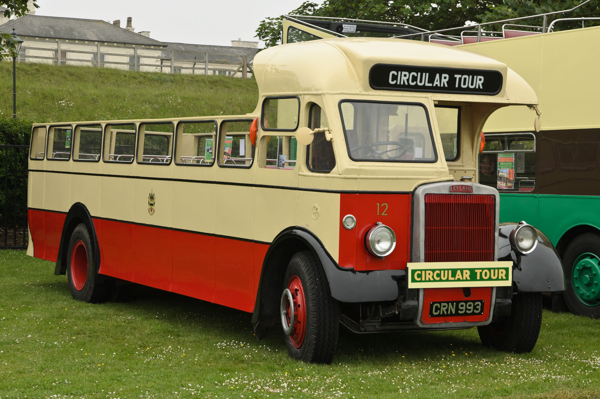 an old fashioned bus is parked on grass