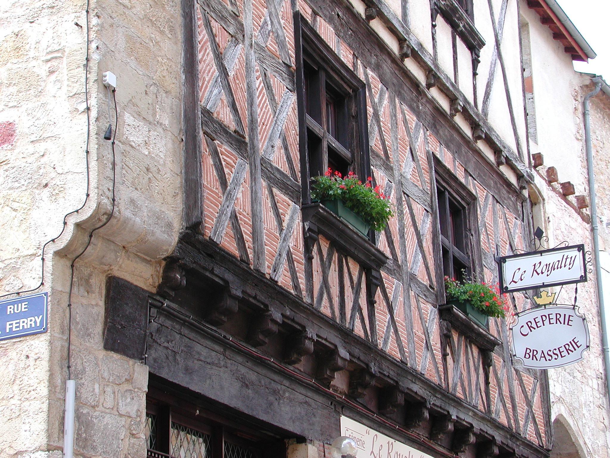 a very old building with two planters that have flowers