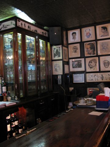 an old fashioned bar with several posters on the wall