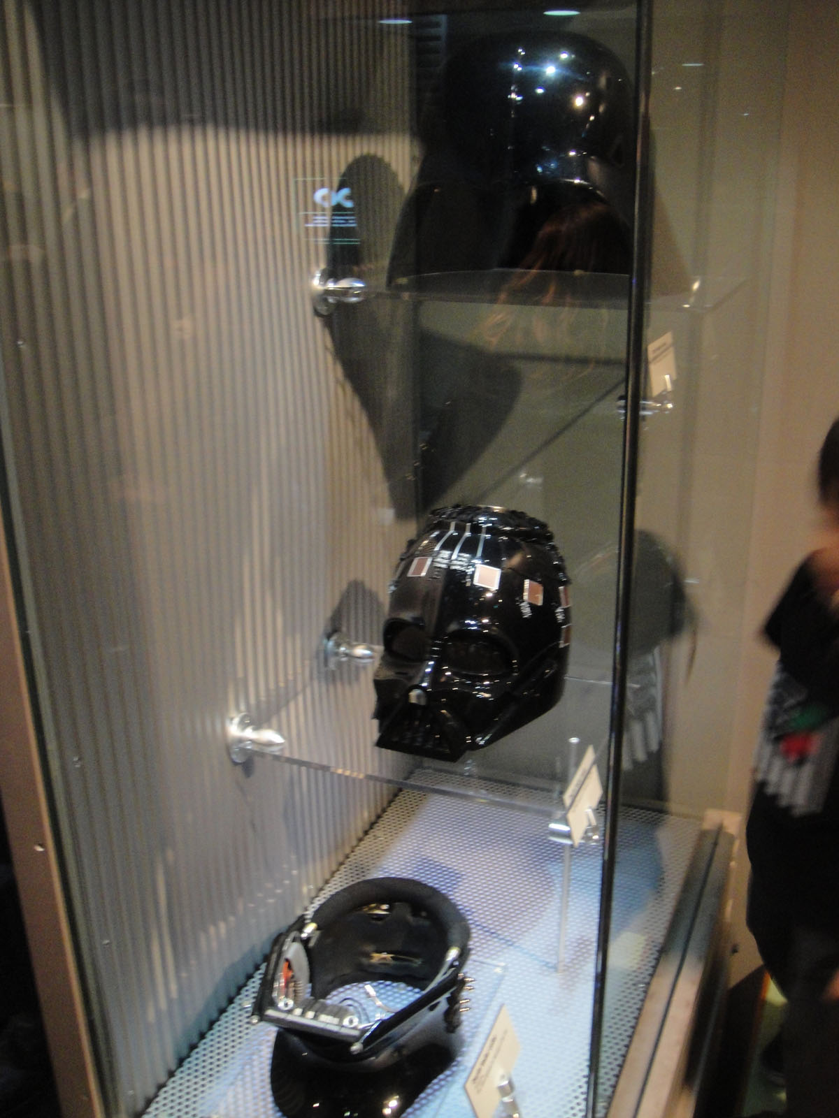 a glass case displays a motorcycle helmet in the background