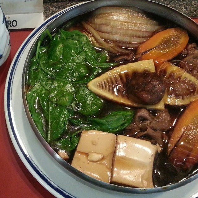a bowl filled with meat, vegetables and mushrooms