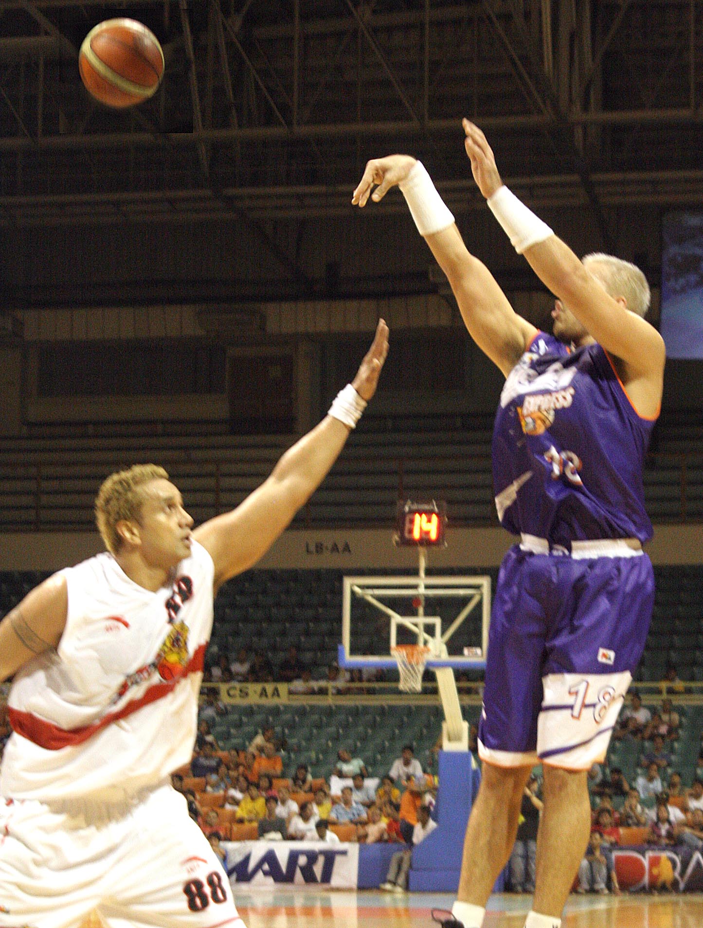 a person is trying to block another player from going for a basketball