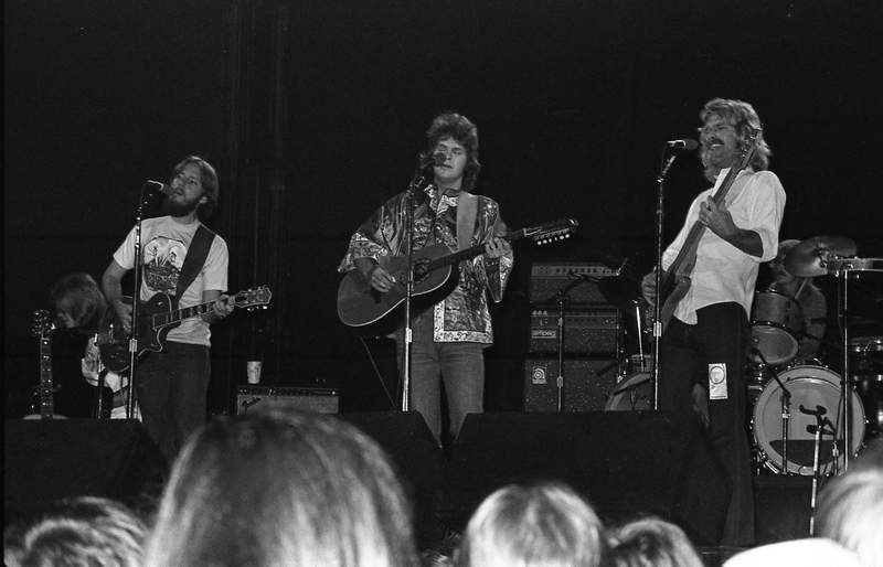 some people are playing on the stage with guitars