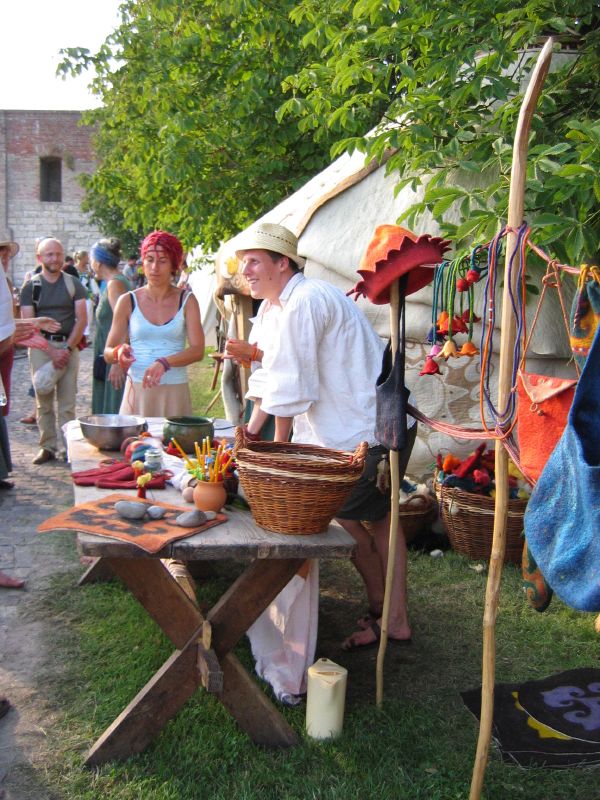 a person stands by a table with baskets of food