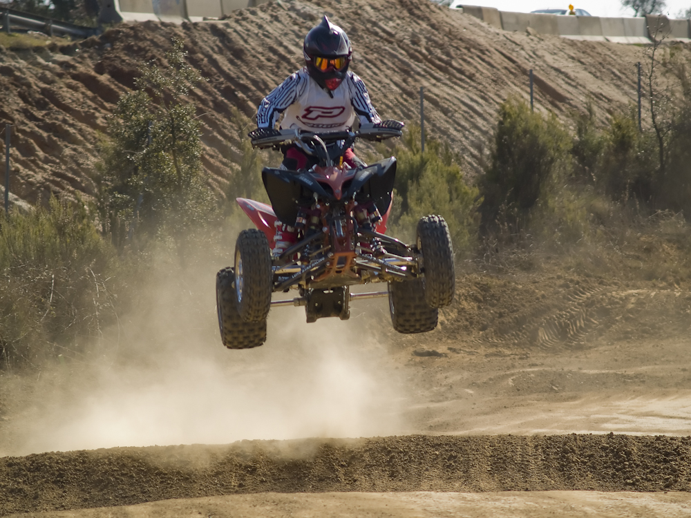 a man jumping on an atv in the air