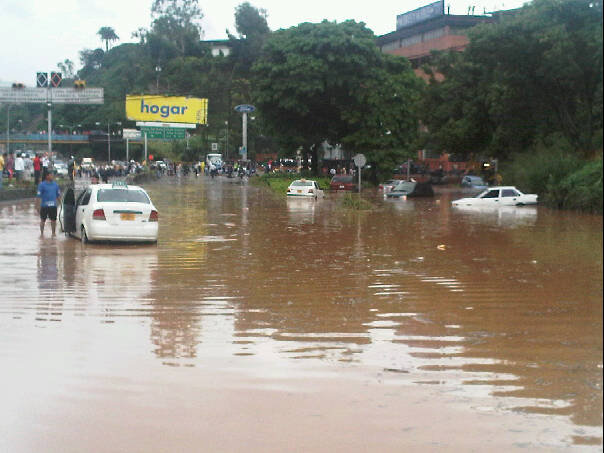 some cars are parked in a flooded street