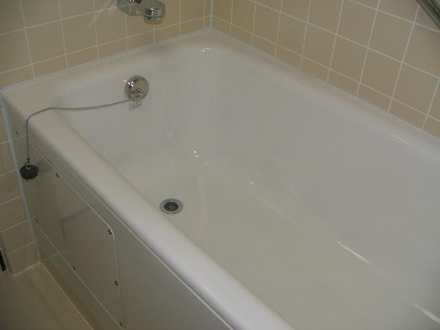 a bath tub with a shower head next to it