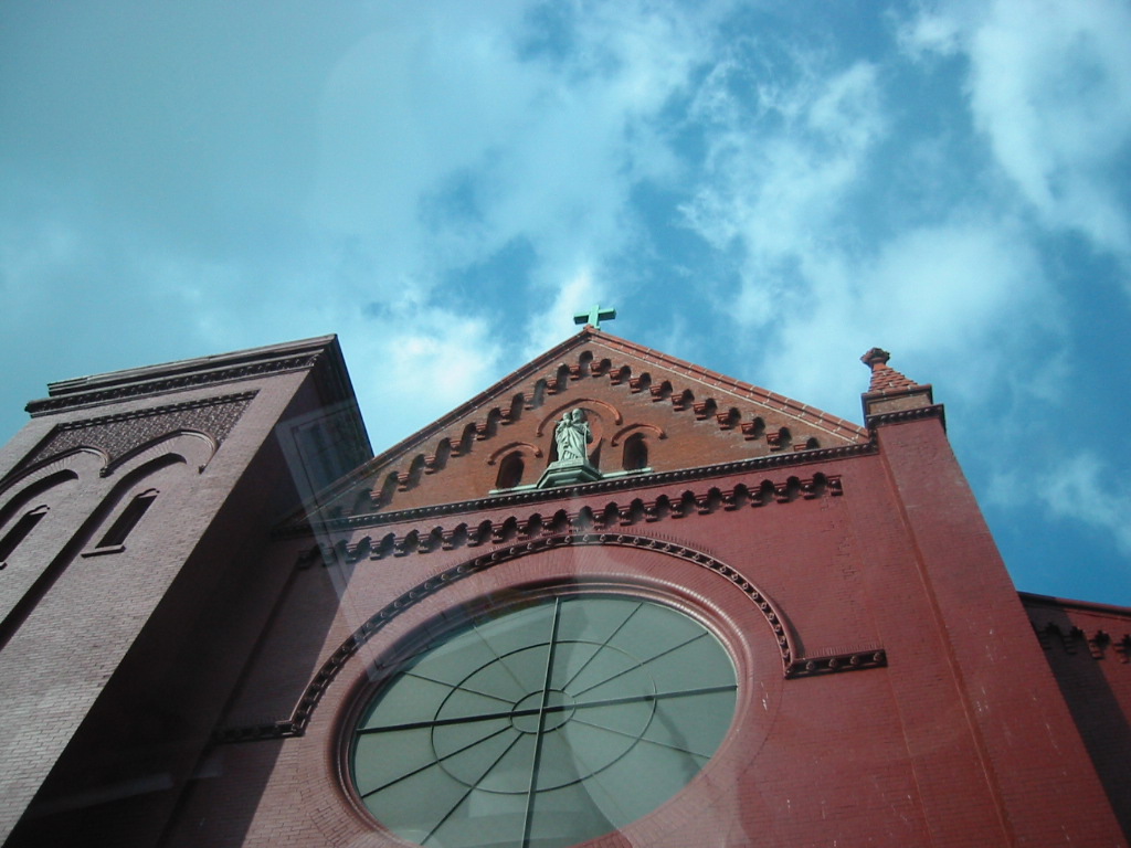 a large window in the side of a tall brick building