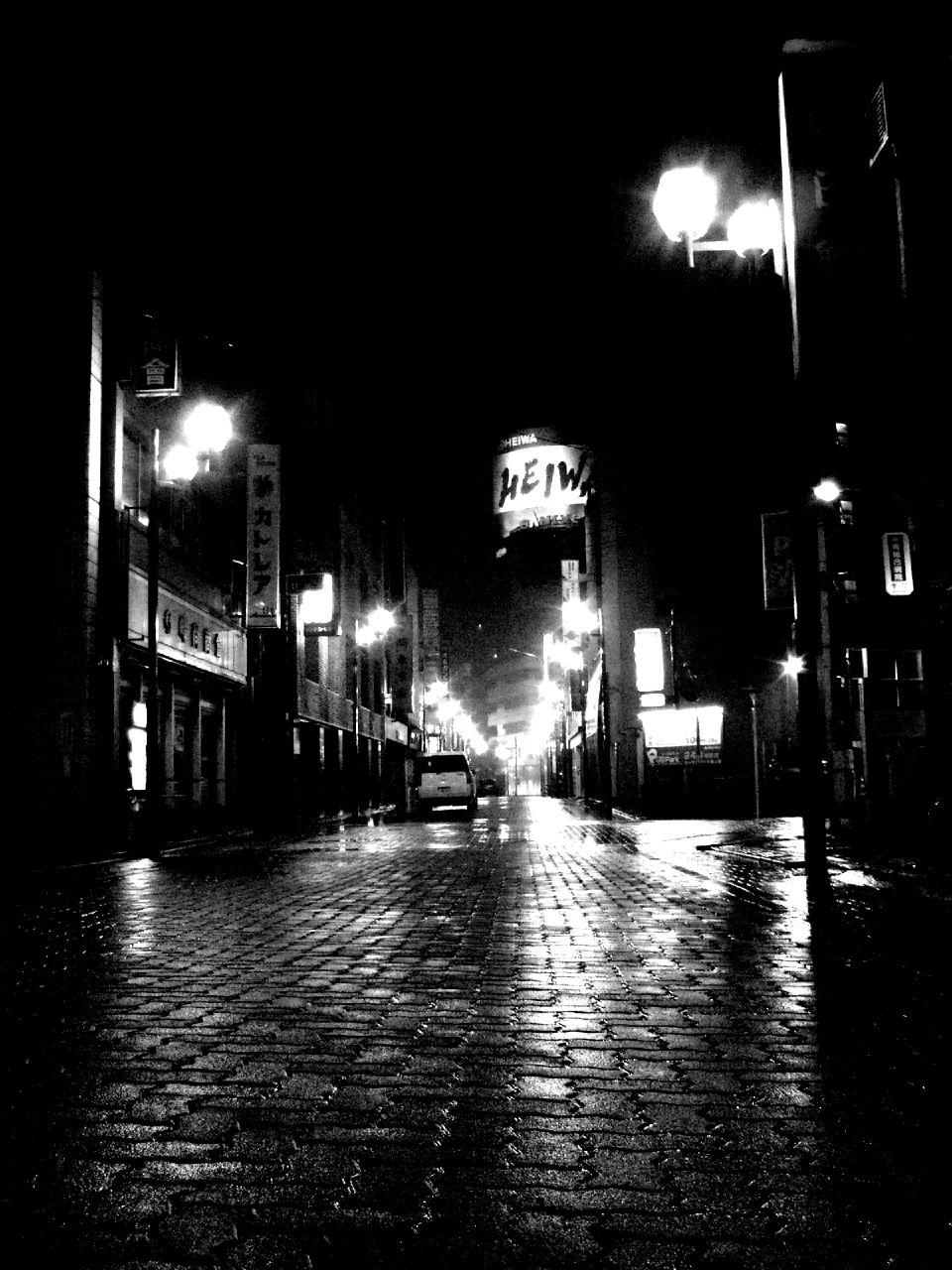 an empty brick street in the dark during the night