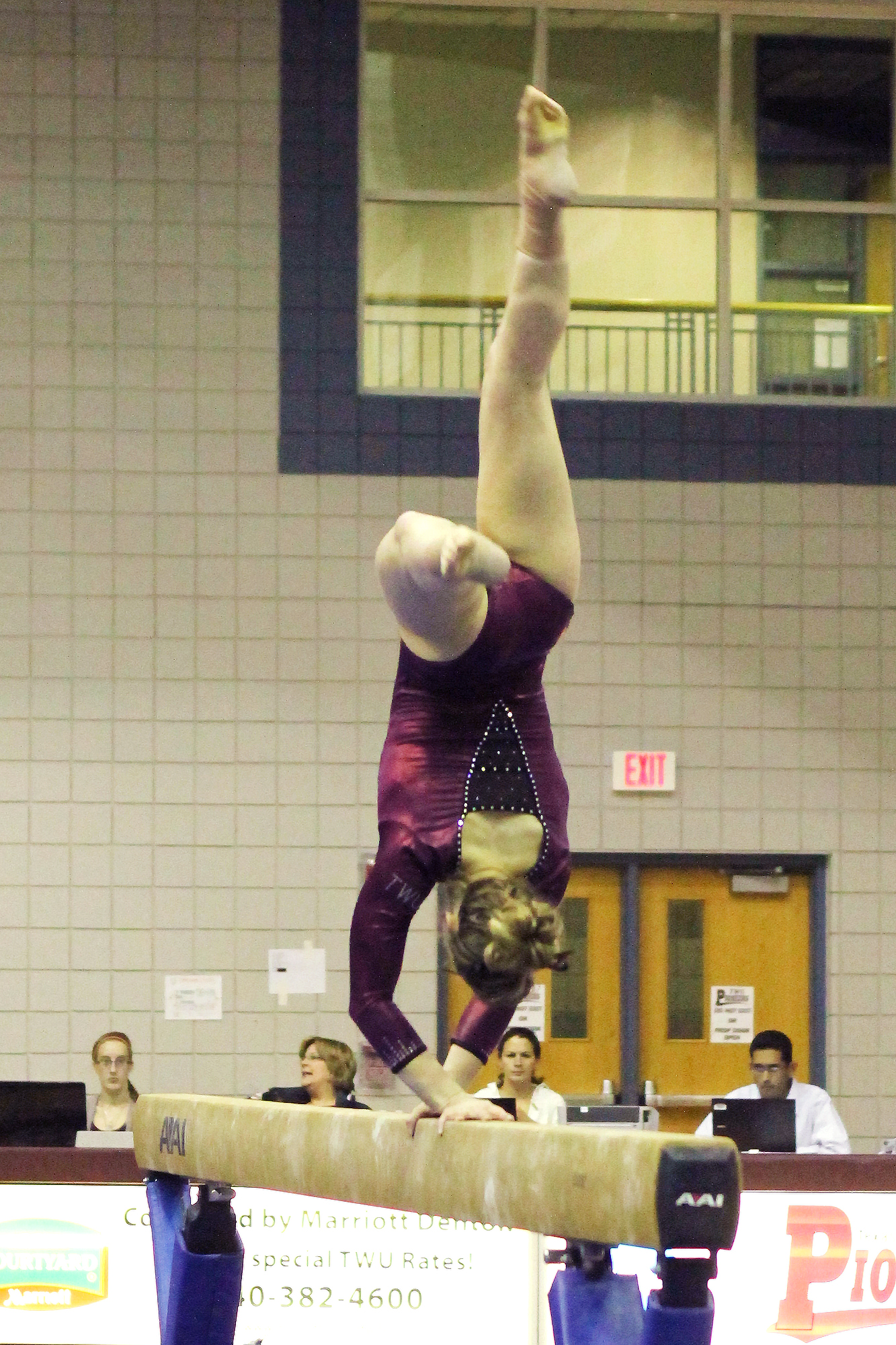 a person jumping off of a beam on the gymnastics track