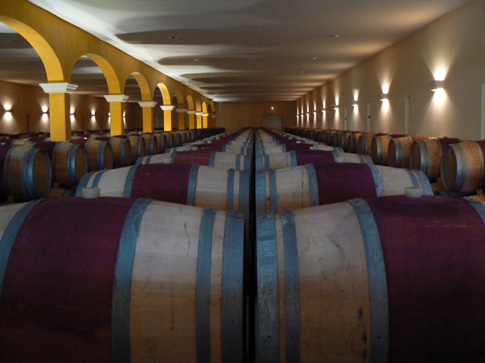 several wooden barrels lined up in an winery