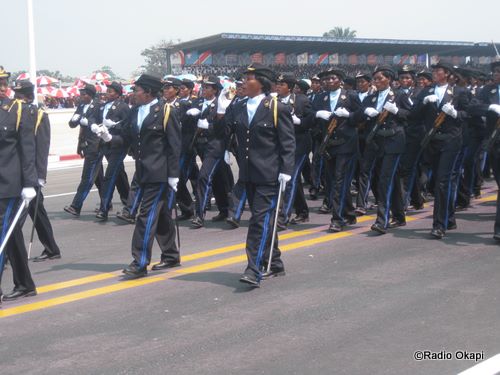group of police officers marching down the street in formation