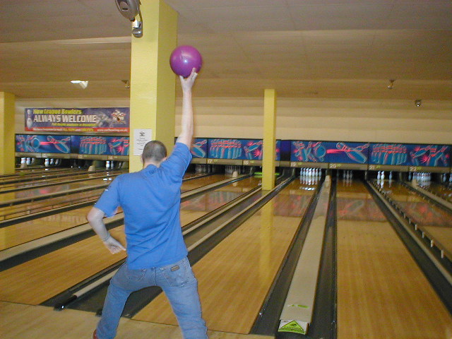 a man is getting ready to throw a purple ball