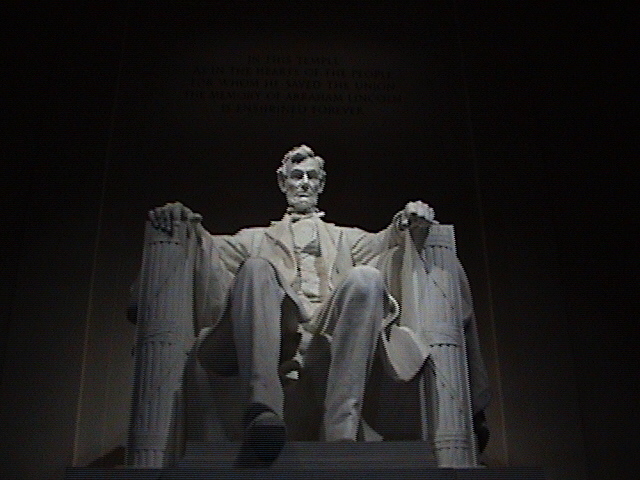 a large white statue of aham lincoln sitting in front of a black background