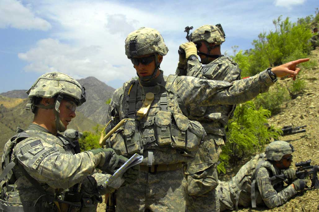 a group of soldiers holding guns while pointing soing