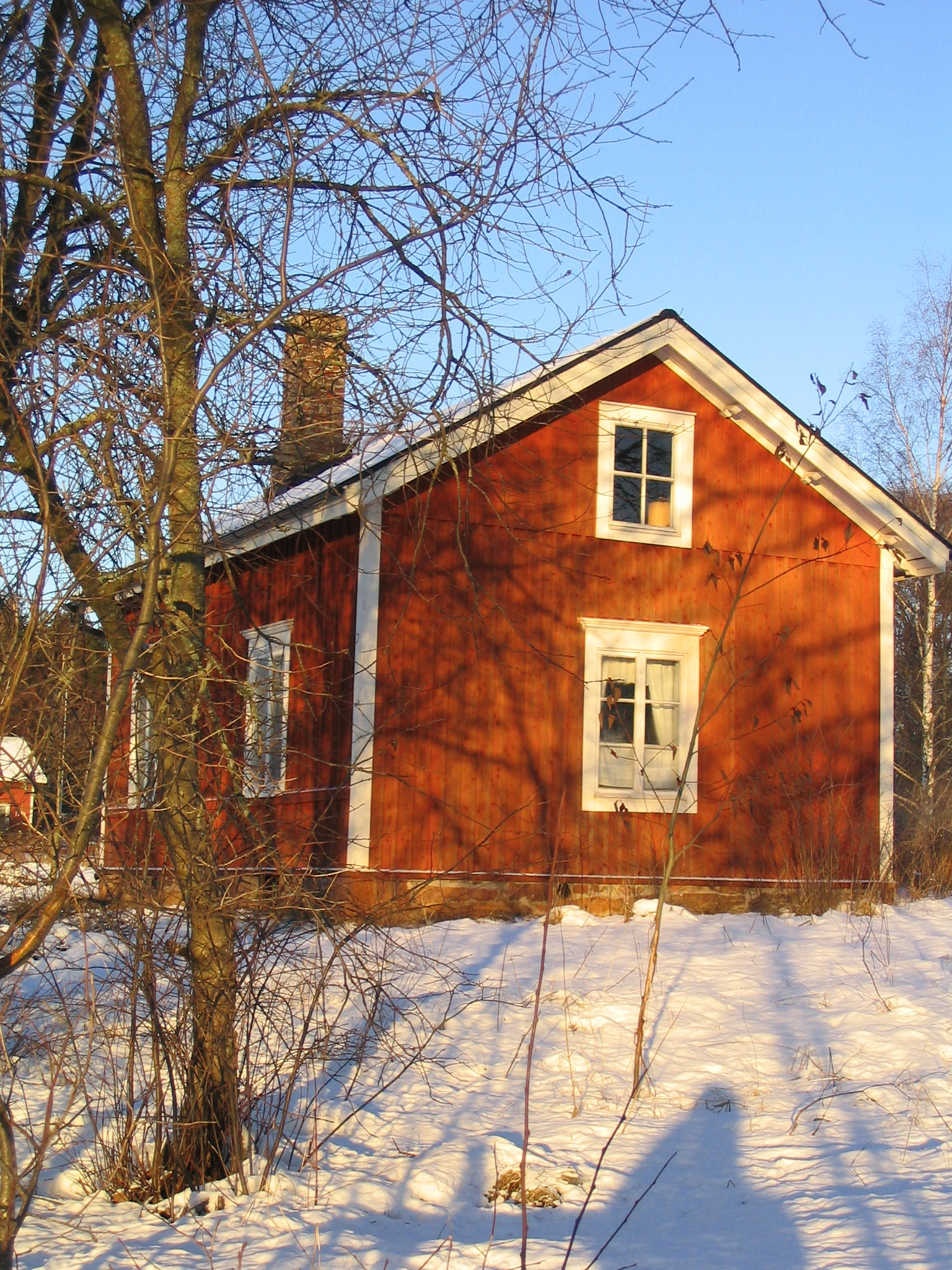 the red house is completely covered by snow