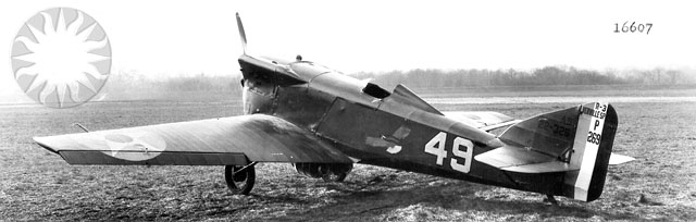 an older military plane in the grass with a badge on the front and side
