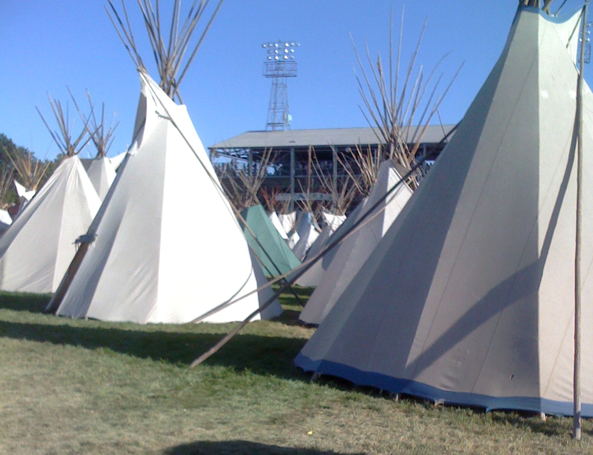 a row of tents with some kind of poles