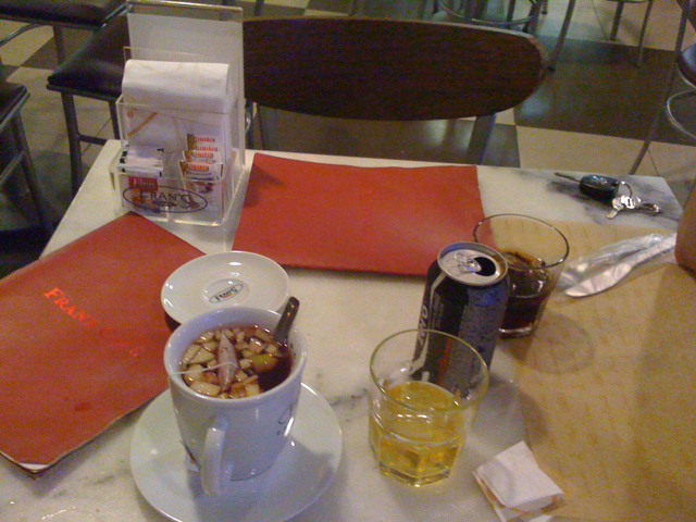 soup, sodas and tea on a table in a restaurant