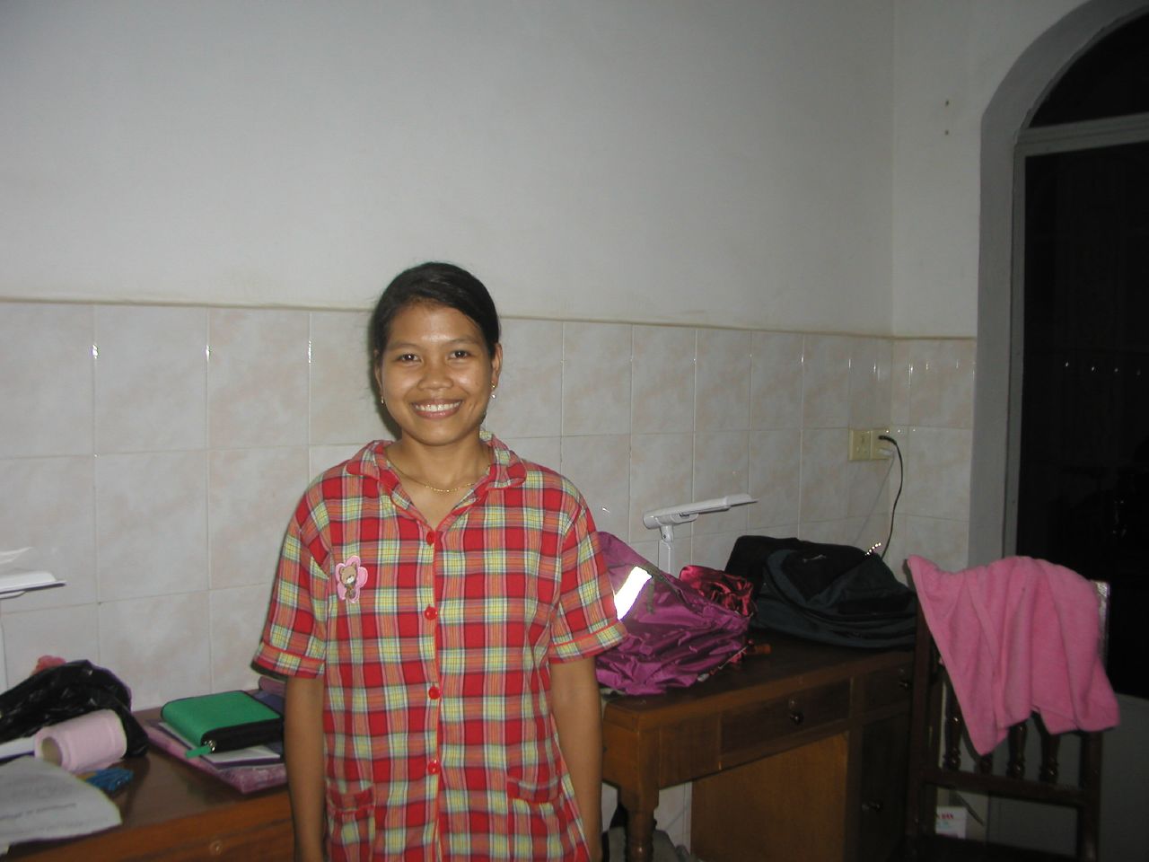 a girl is smiling and posing for the camera