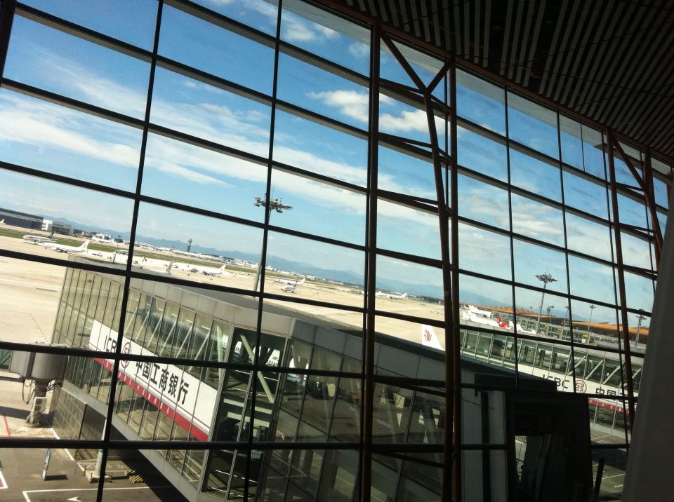 the view of an airport through windows in a building