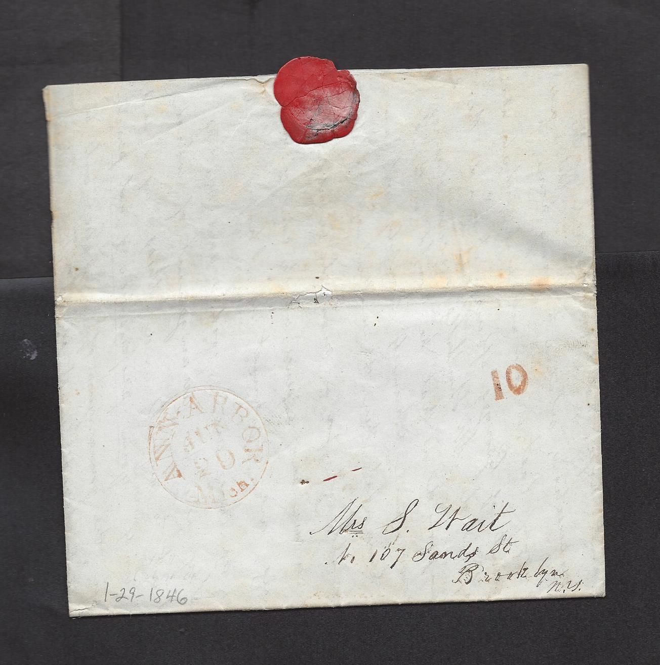 an old envelope with a wax stamp and some writing