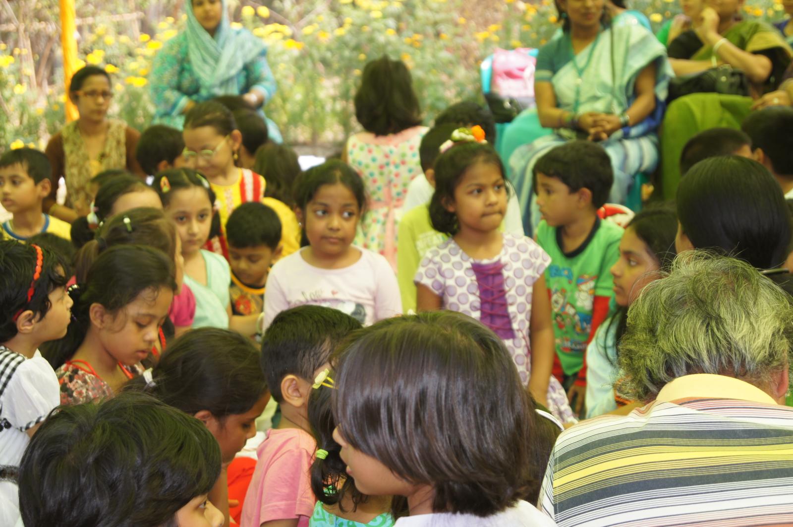 a group of children standing together in a large room