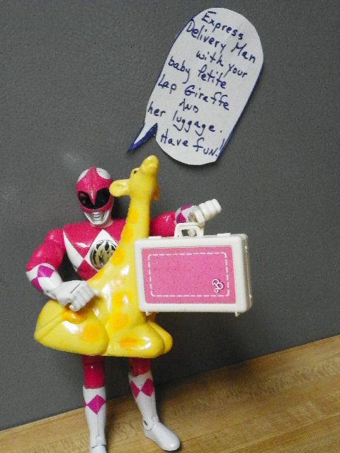 action figure standing with handwritten note and a giraffe