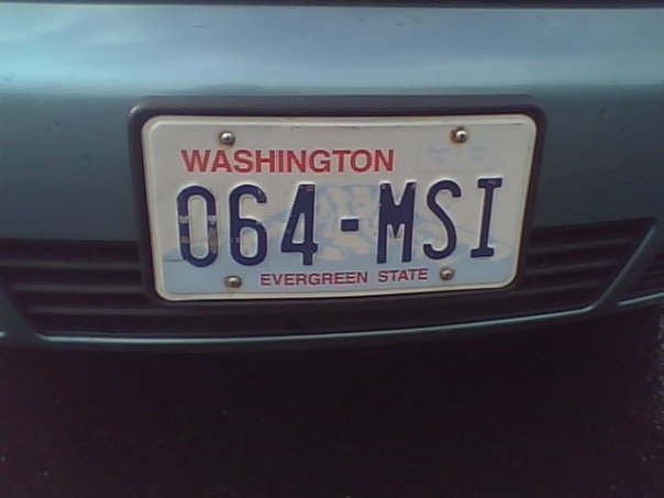a washington plate is sitting on a silver car