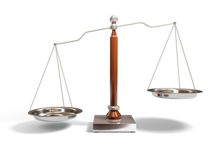 a metal balance on two pans is sitting