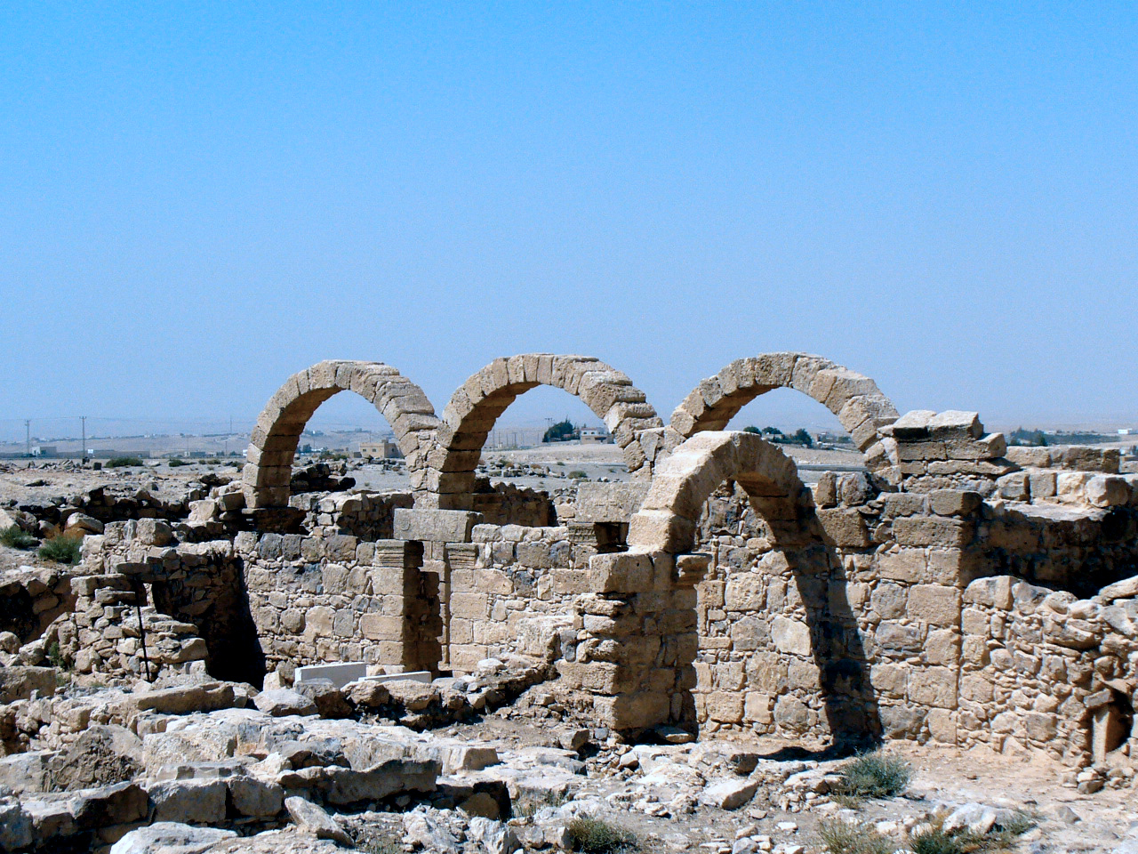 several archways sit on top of rocks in the desert