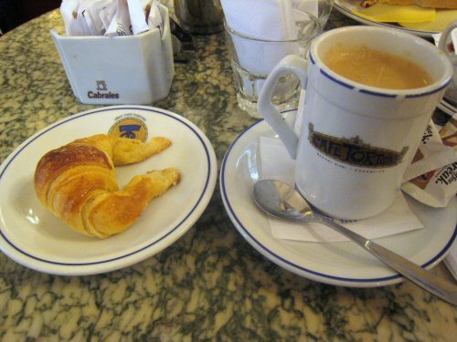 coffee and pastries in plates on the counter